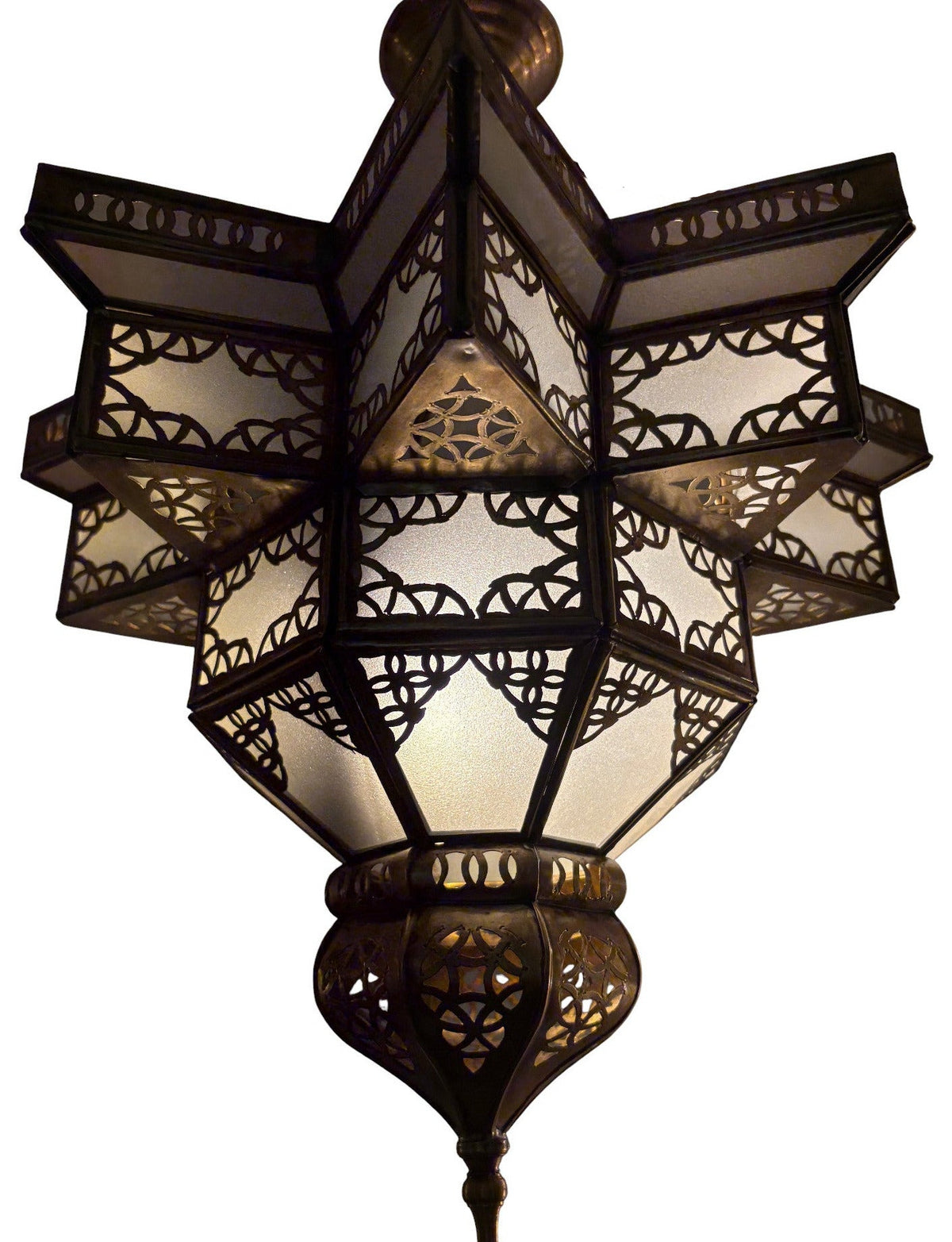 An ornate geometric hanging lantern with intricate cutout metalwork and glowing warm white glass panels, shown against a plain white background.