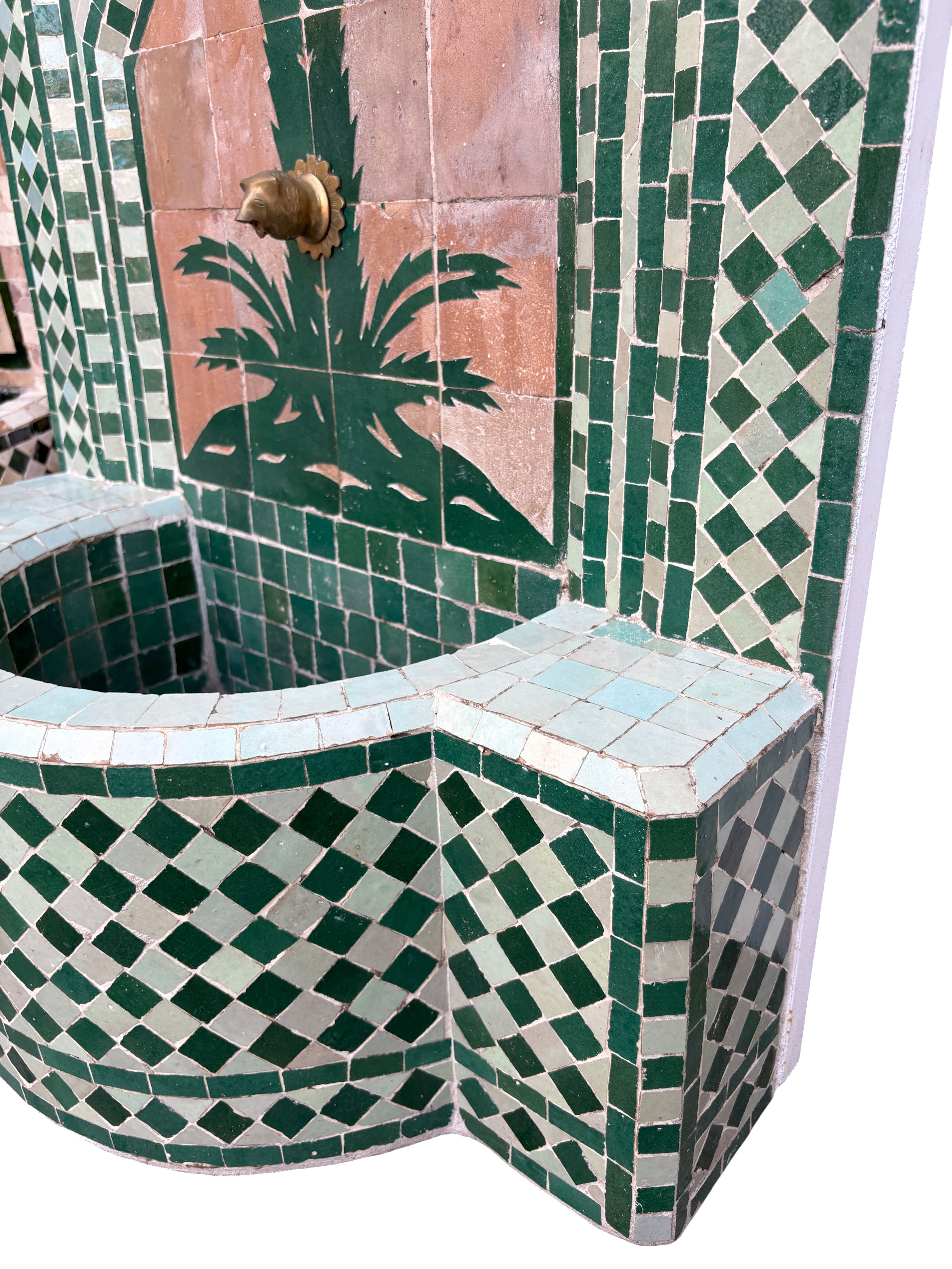 Mosaic tiled fountain with geometric patterns and a palm tree design.