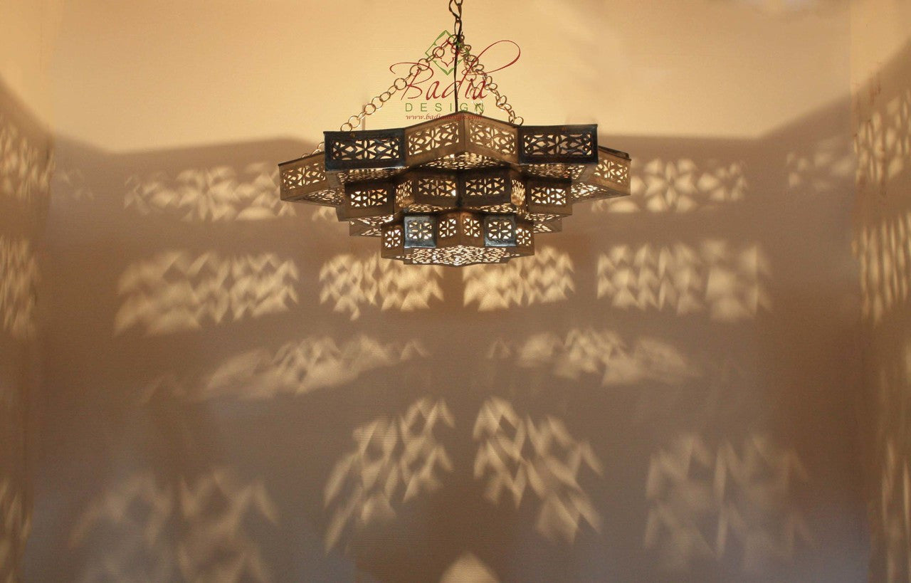 Decorative chandelier casting shadows on a wall