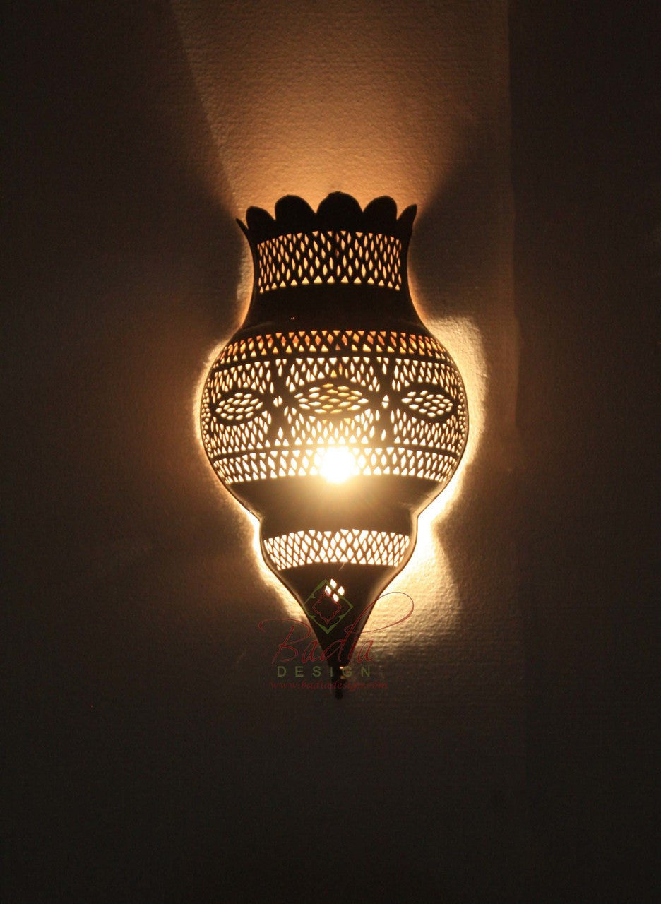 Decorative wall lamp with intricate patterns on a dark background