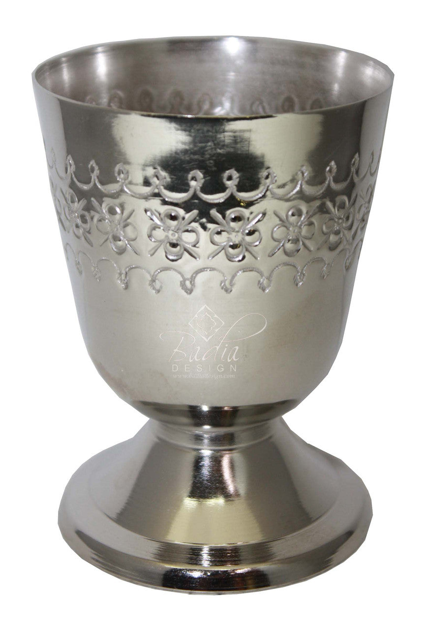 Silver goblet with intricate patterns on a white background