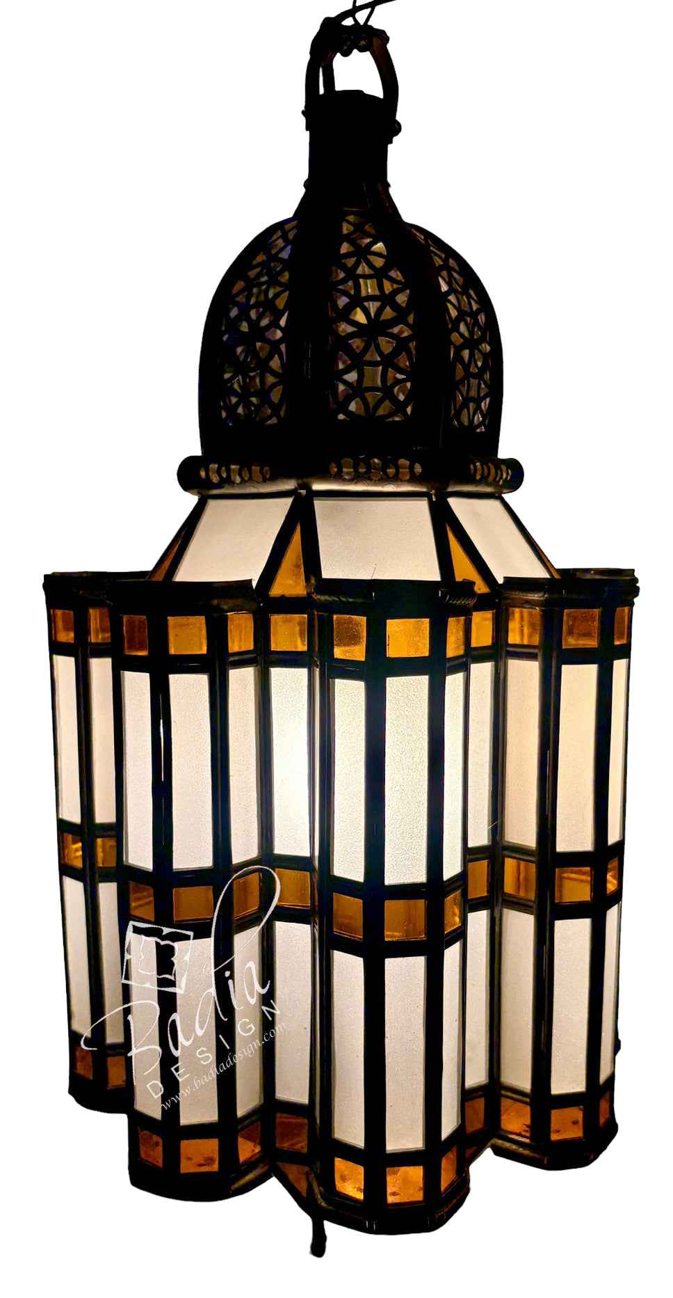 A hanging Moroccan-style lantern with a black metal frame and domed top, featuring cream-colored glass panels and amber-tinted glass accents, shown against a white background.