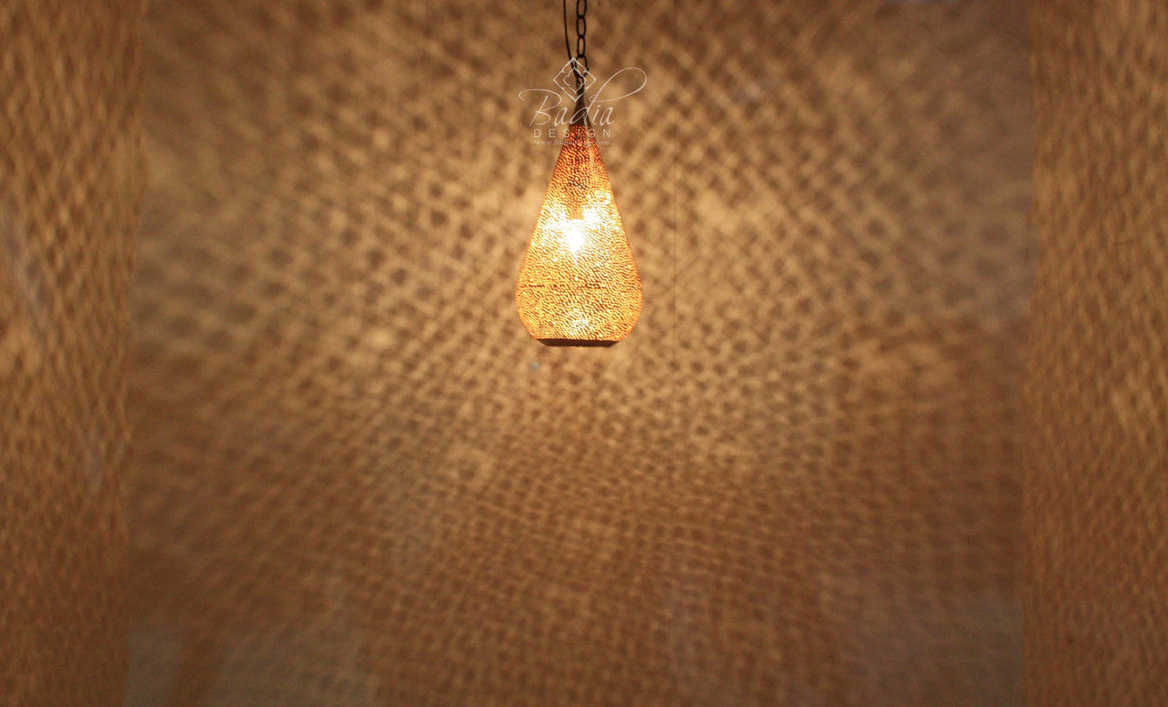 Decorative light bulb hanging against a textured brown wall