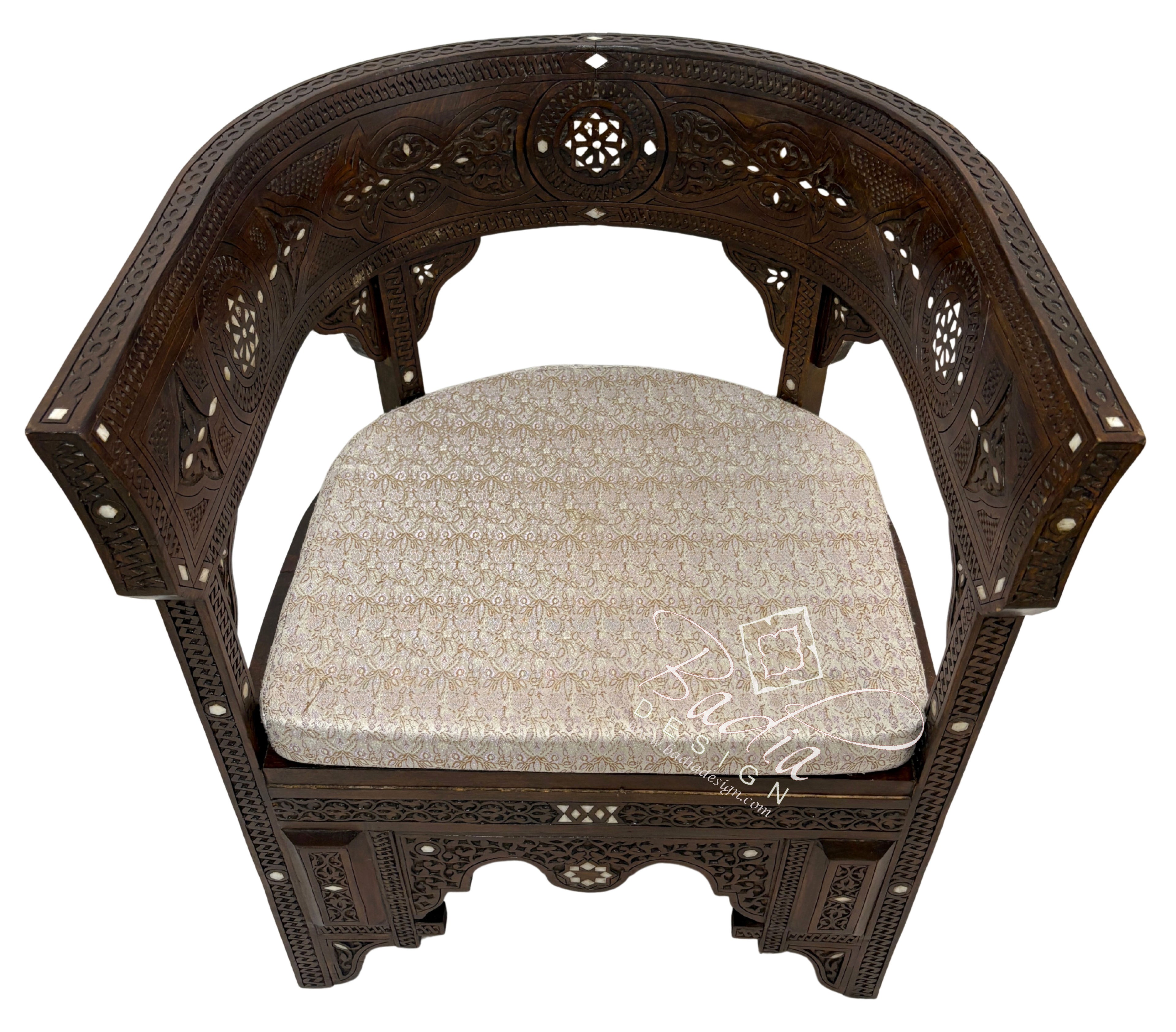 Decorative wooden chair with intricate carvings and a patterned cushion on a white background.