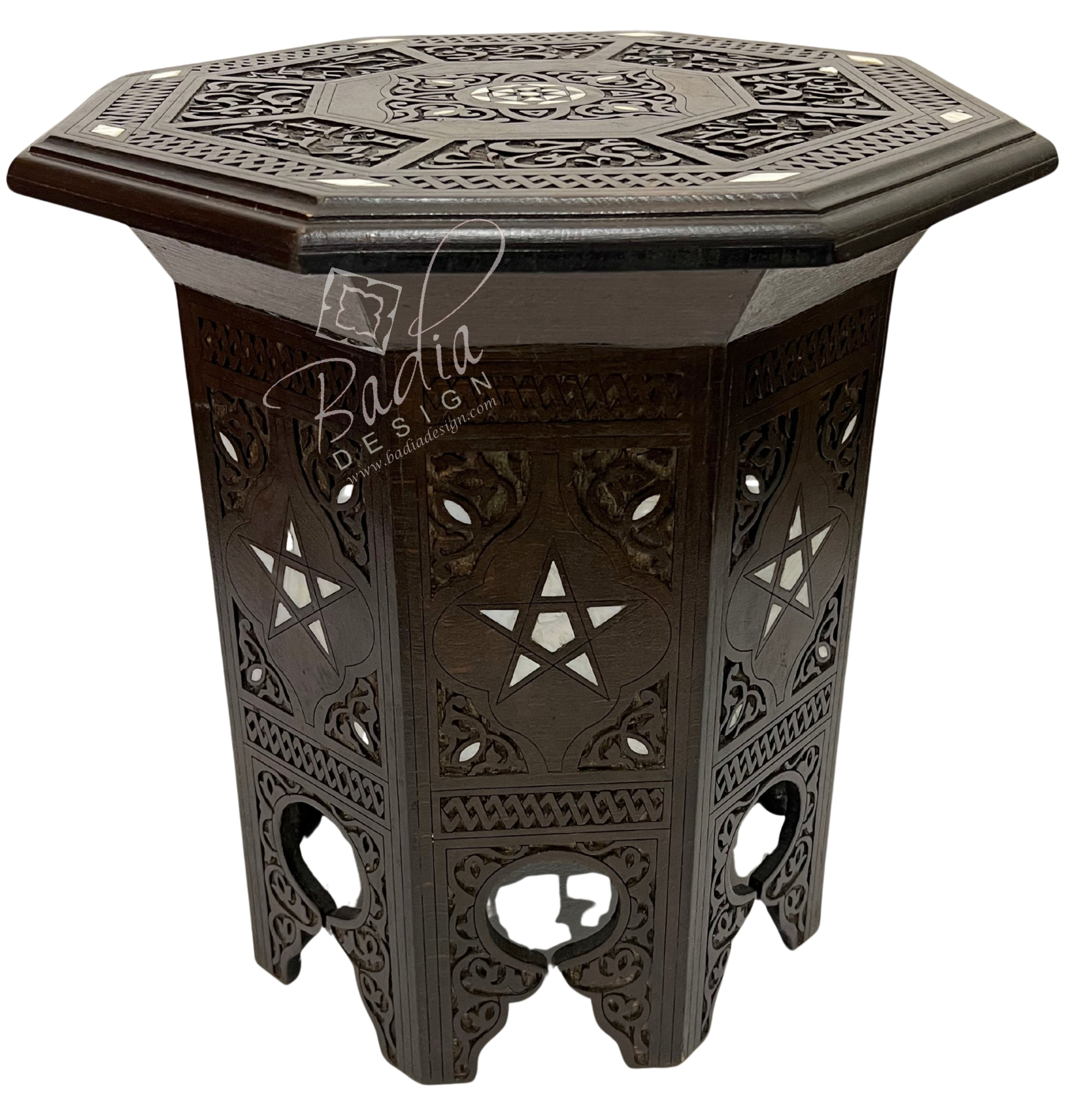 Decorative hexagonal side table with intricate patterns on a white background