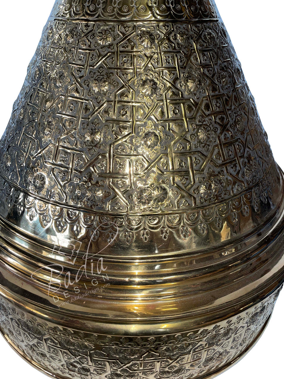 Decorative metal object with intricate patterns on a white background