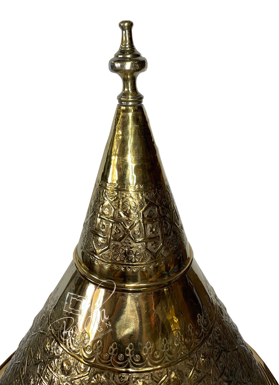 Decorative brass lamp with intricate patterns on a white background