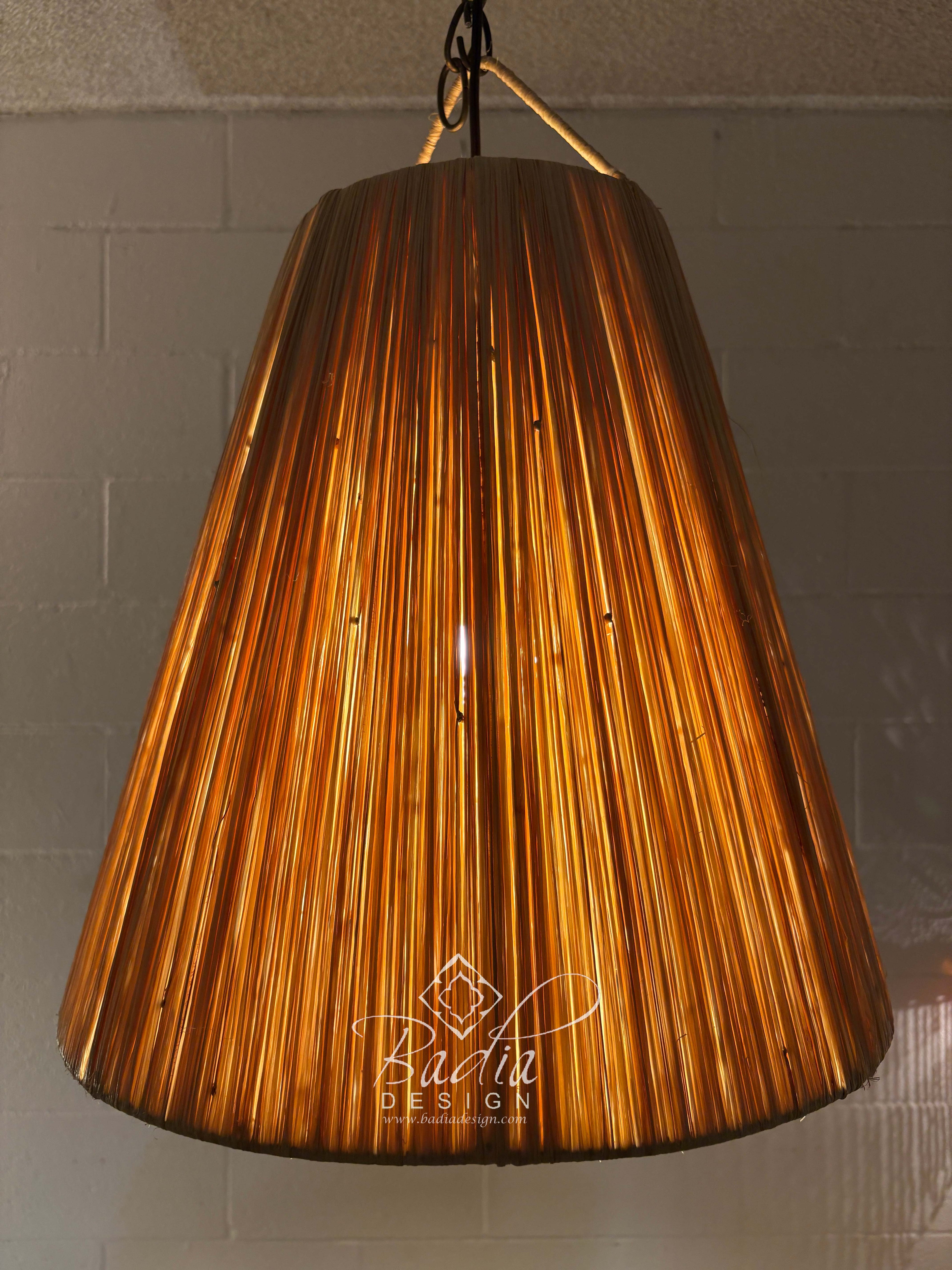 Decorative pendant light with a textured brown shade on a neutral background