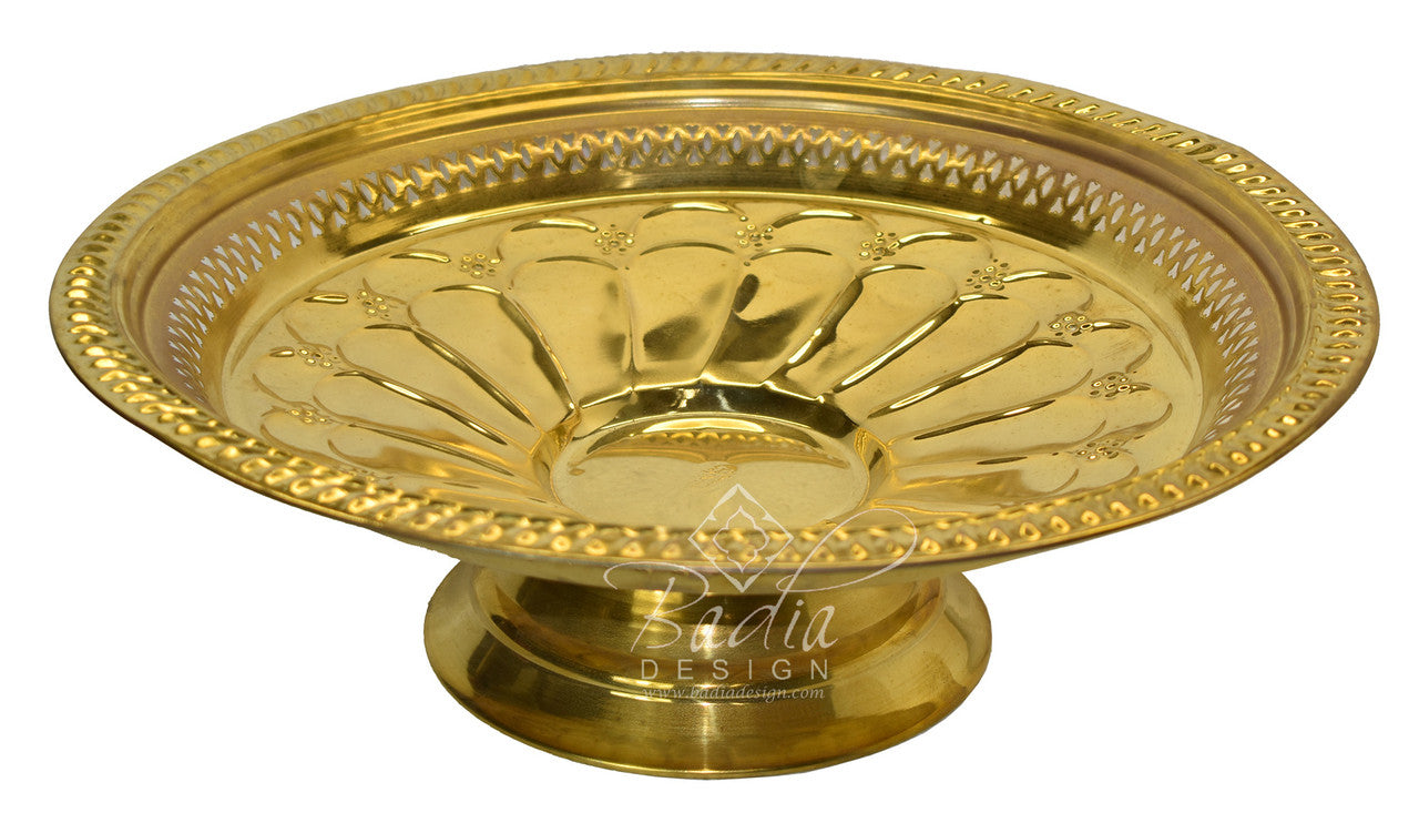 Decorative gold tray with intricate designs on a white background