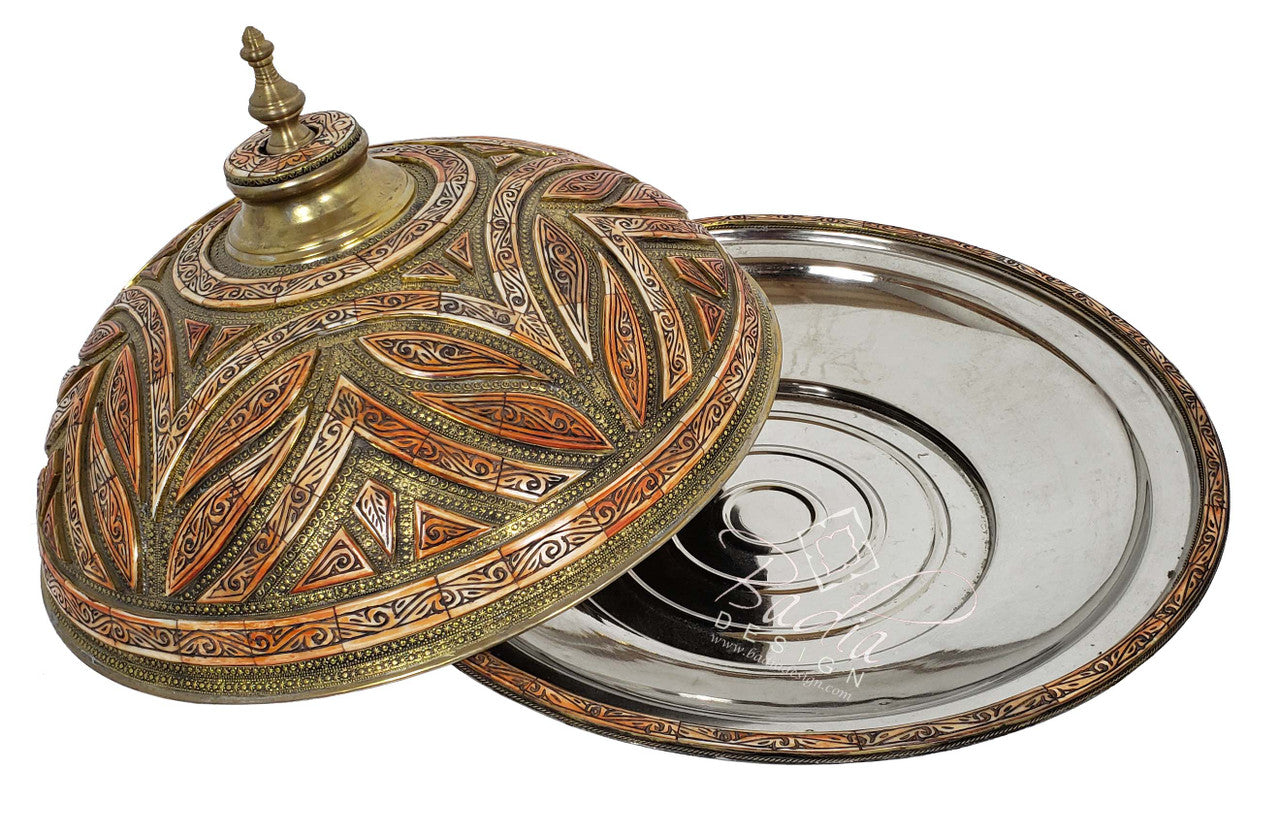 Decorative metal lid with intricate patterns on a white background