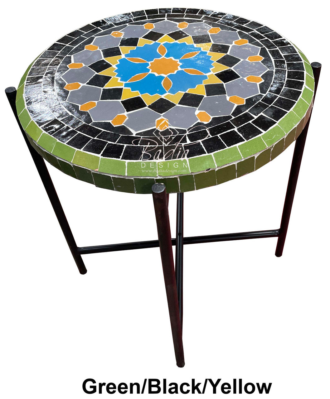 Round mosaic table with green, black, and yellow pattern on a white background