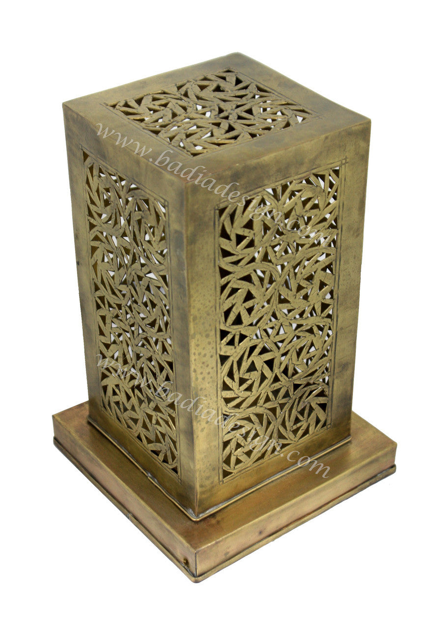Decorative metal lantern with intricate cut-out patterns on a white background