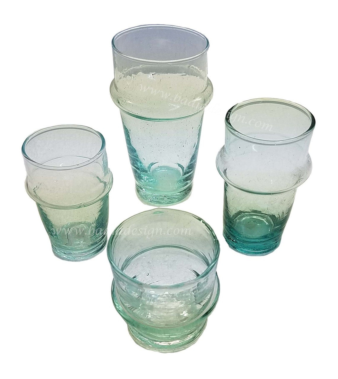 Set of six green glass tumblers on a white background