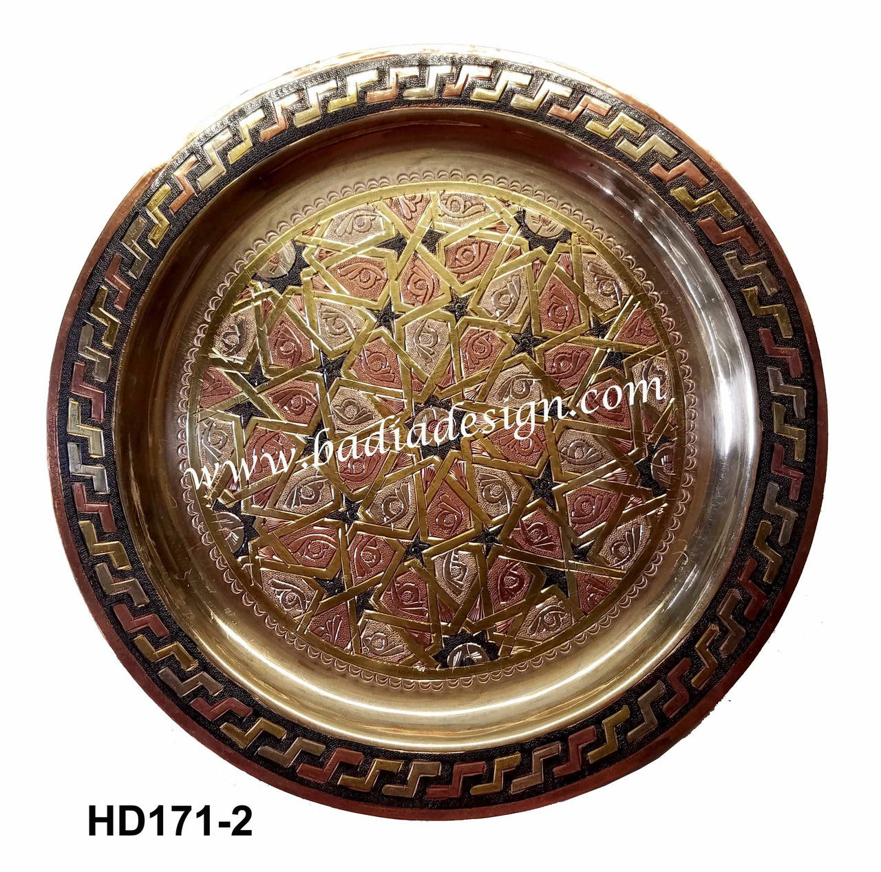 Decorative metal tray with intricate patterns on a white background