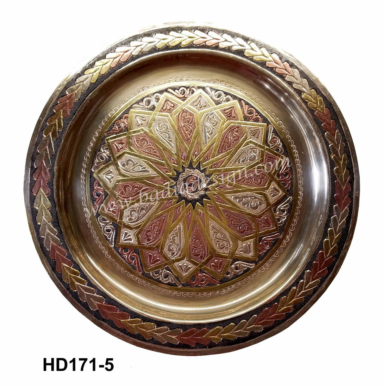 Decorative metal tray with intricate patterns on a white background