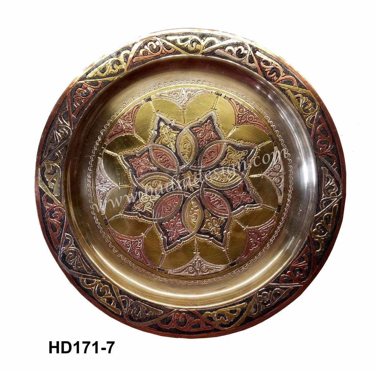 Decorative metal plate with intricate designs on a white background