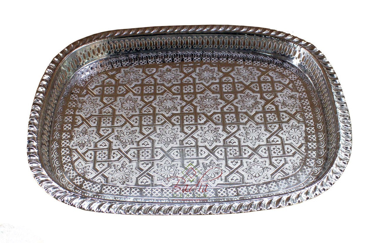 Decorative metal tray with intricate patterns on a white background