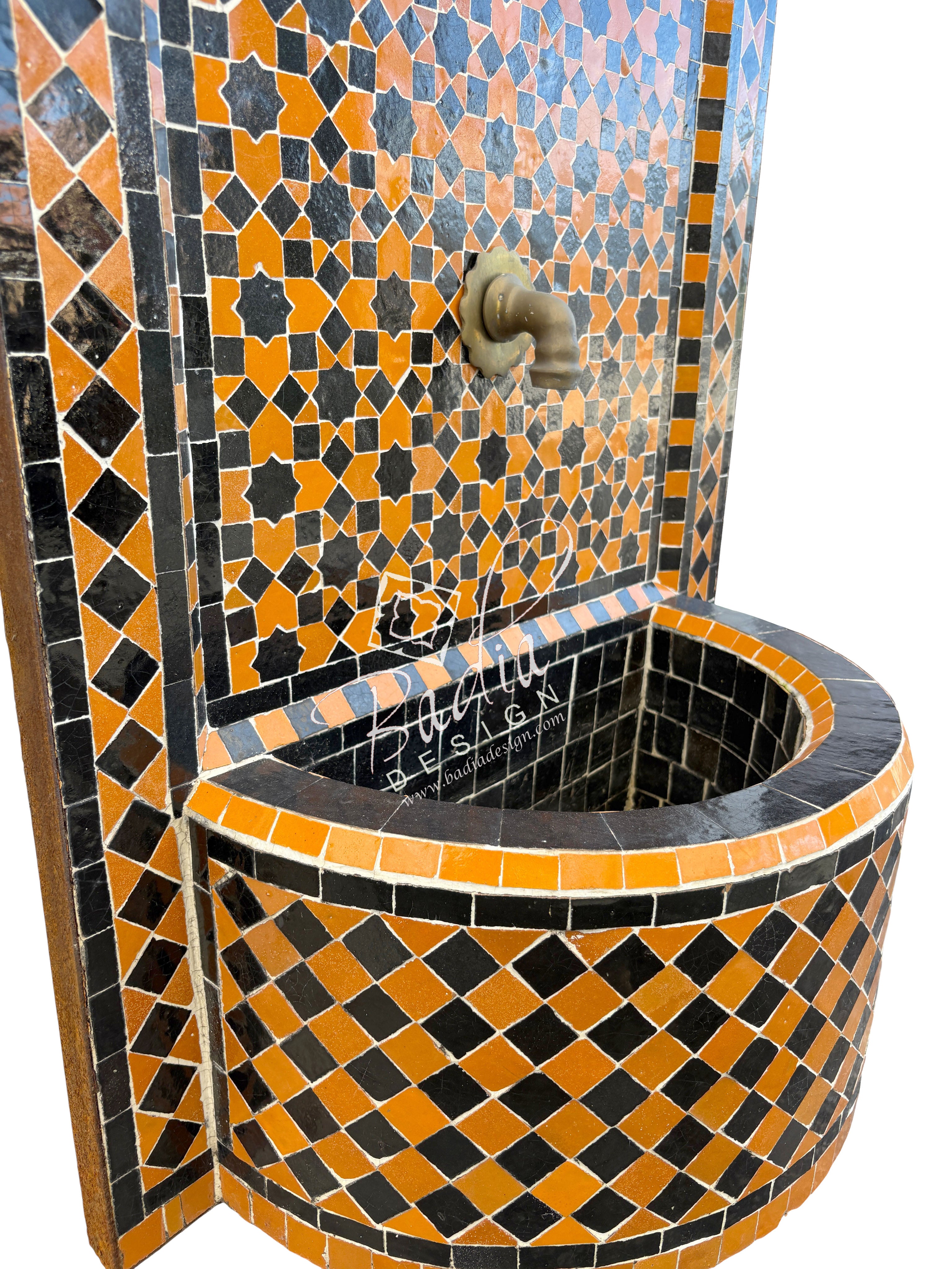 Mosaic-tiled sink with geometric pattern in orange, black, and blue