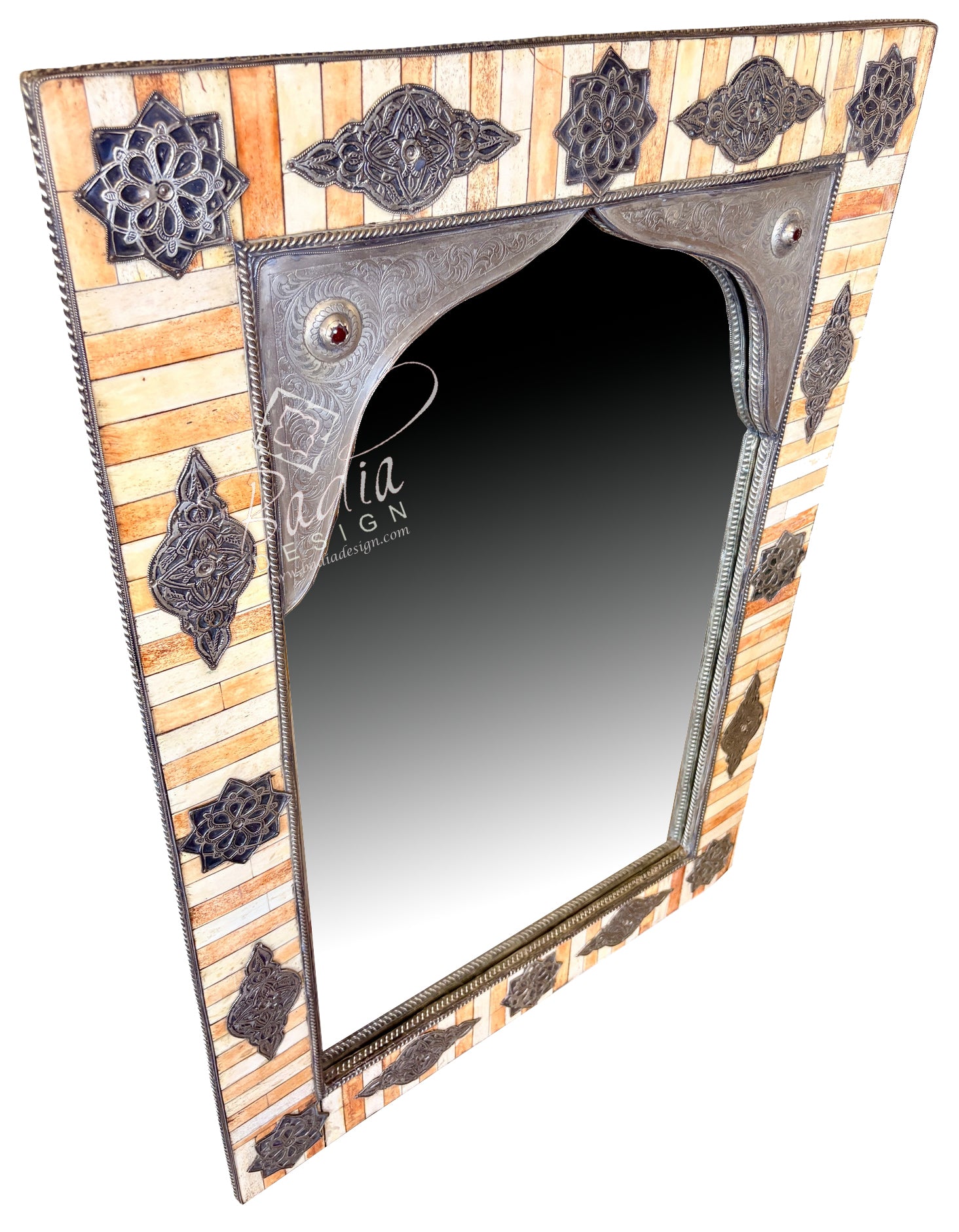 A rectangular wall mirror with an ornate hand-carved frame featuring geometric patterns and metallic accents, set against a plain white background.