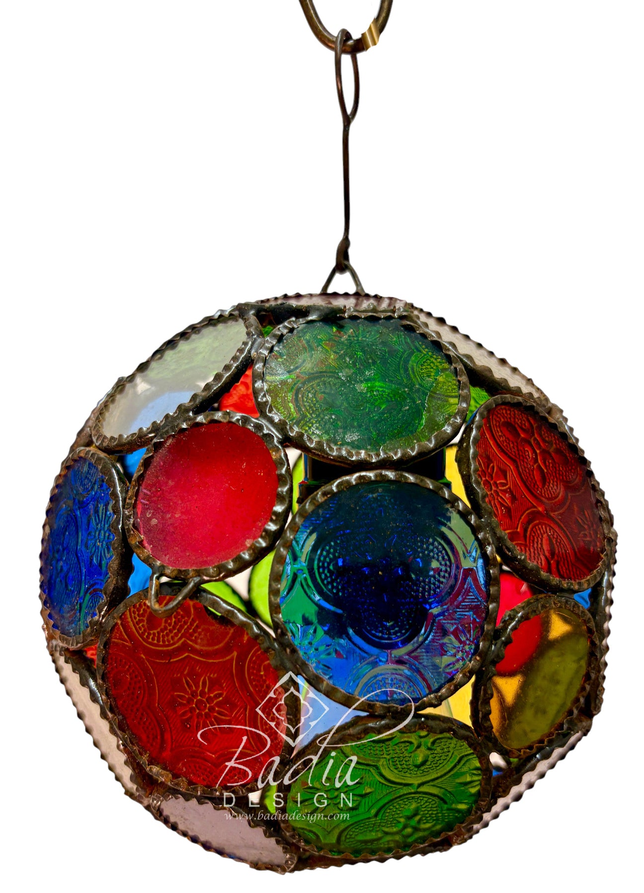 A spherical stained glass ornament featuring a mosaic of colorful glass panels in red, blue, green, yellow, and purple, framed by a distressed silver-tone metal border and suspended by a metal ring against a white background.