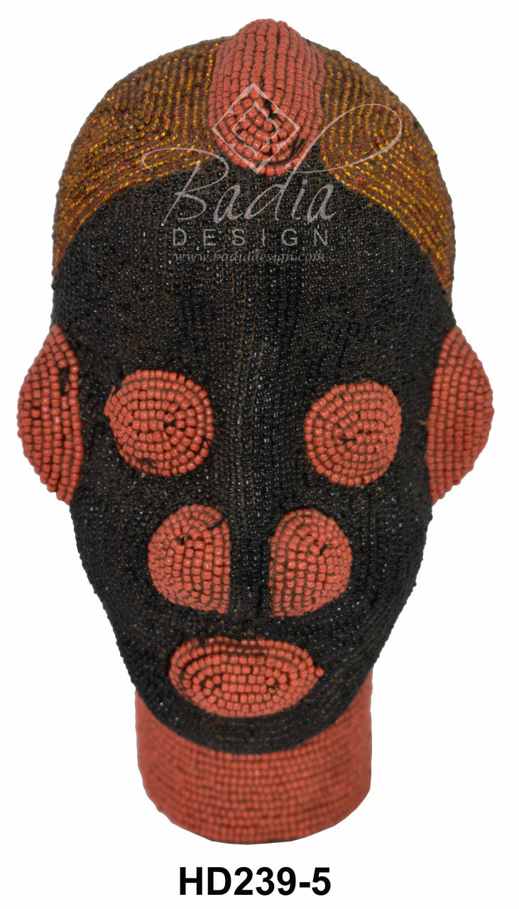 Beaded African head with intricate patterns on a white background
