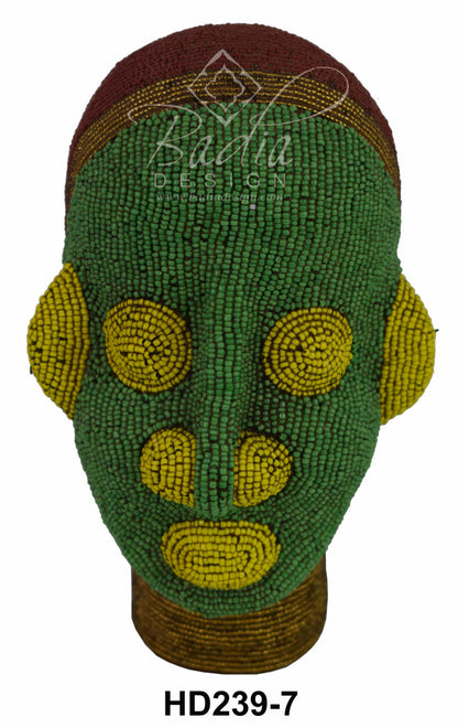 Decorative beaded gead with green and yellow patterns on a white background