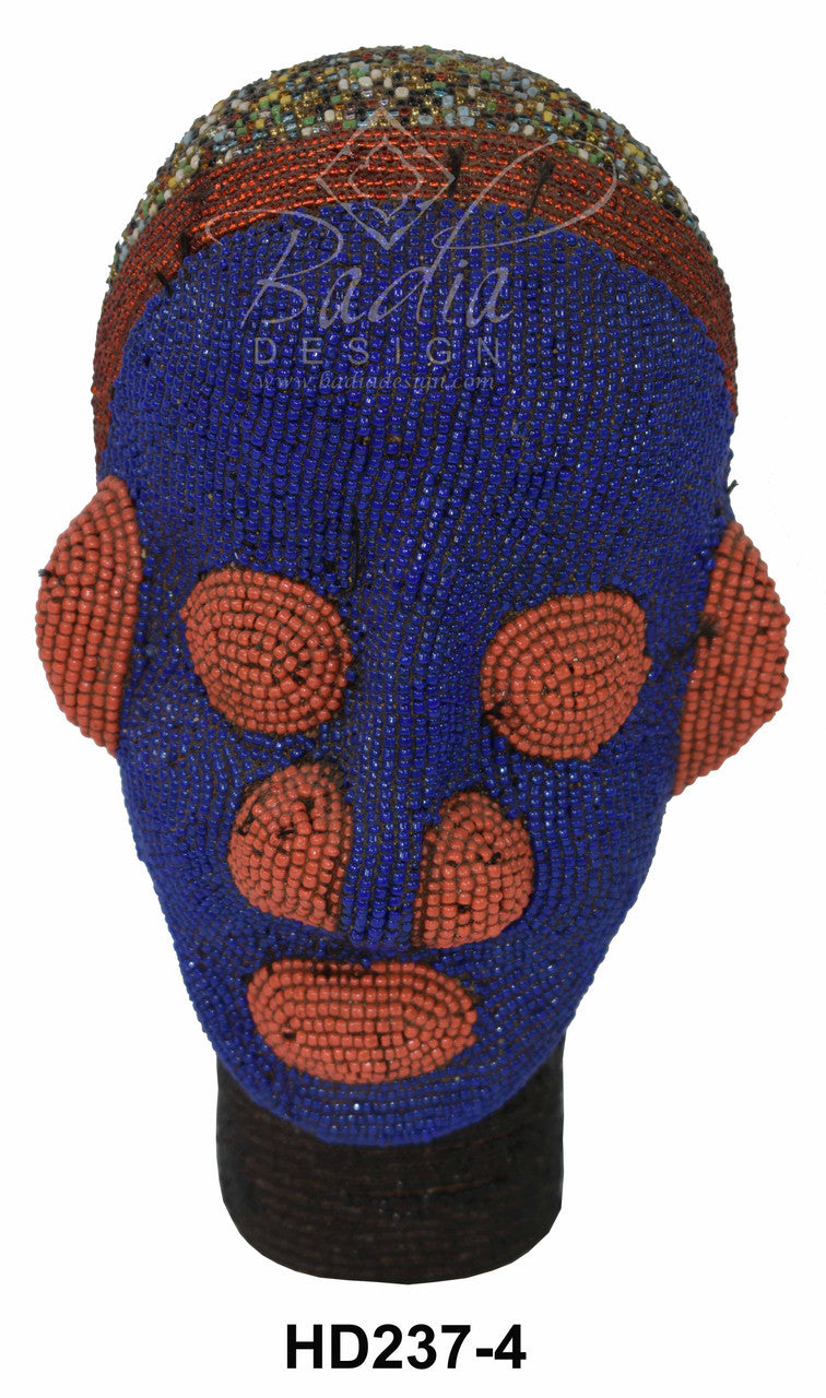 Beaded head with blue and orange design on a white background