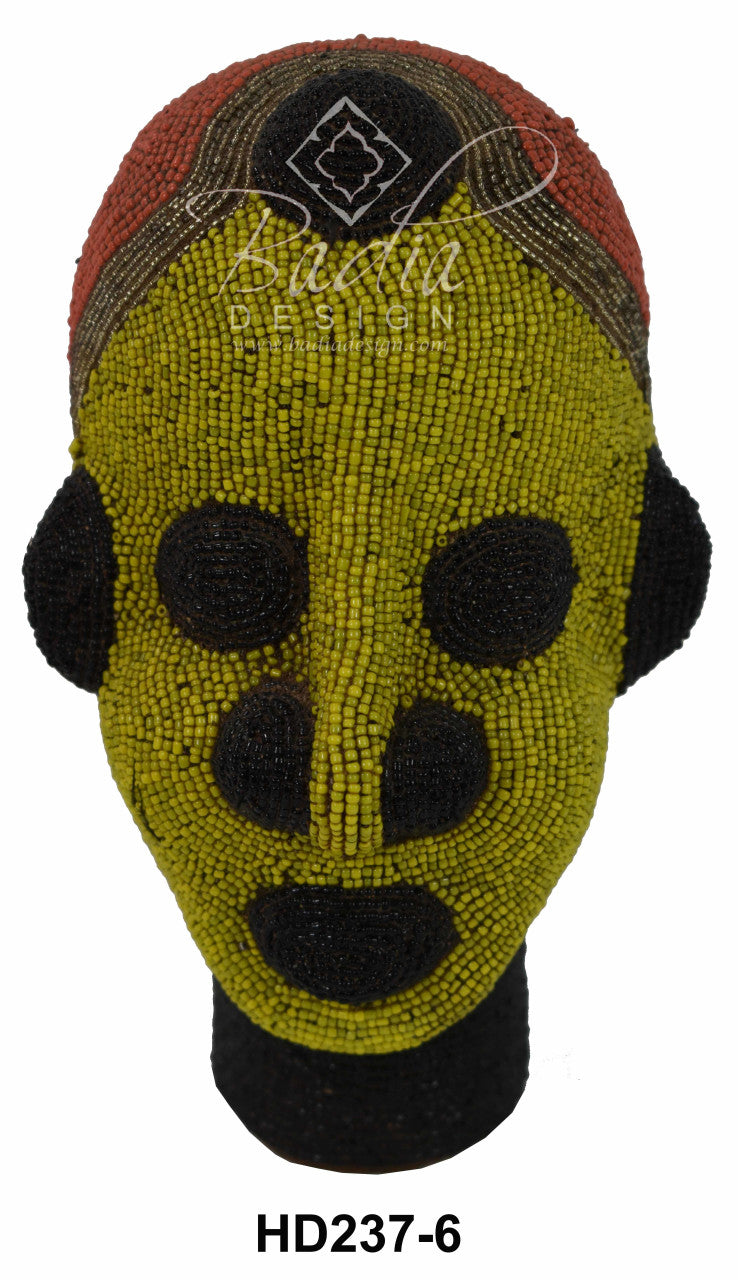 Decorative head with green face and black accents on a white background