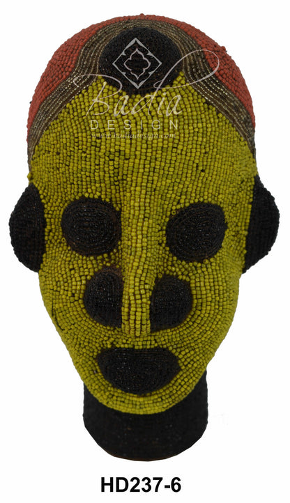 Decorative head with green face and black accents on a white background