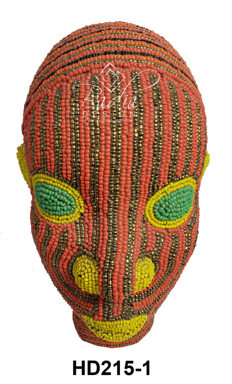 Decorative beaded head with red, green, and yellow patterns on a white background