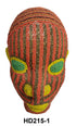 Decorative beaded head with red, green, and yellow patterns on a white background