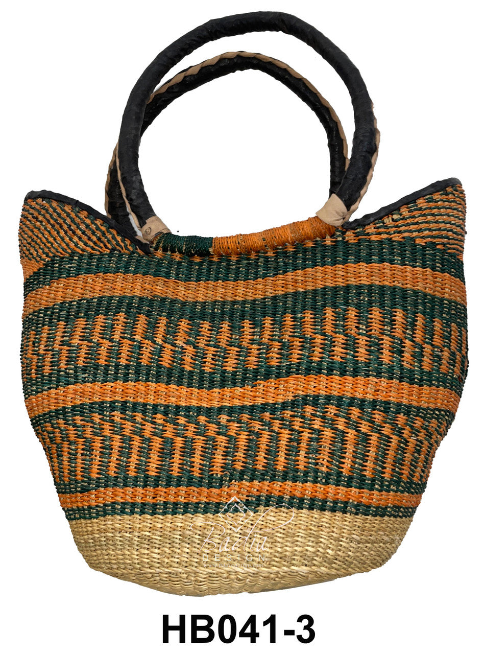 Woven raffia handbag with orange  colorful patterns and leather handles.