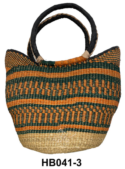 Woven raffia handbag with orange  colorful patterns and leather handles.