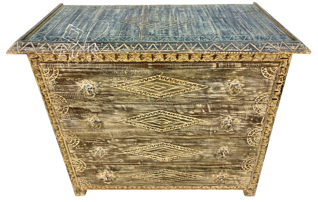 A distressed vintage-style wooden chest with a weathered brown and gold finish, featuring carved geometric diamond patterns and ornate gold-toned handles on the front, set against a plain white background.