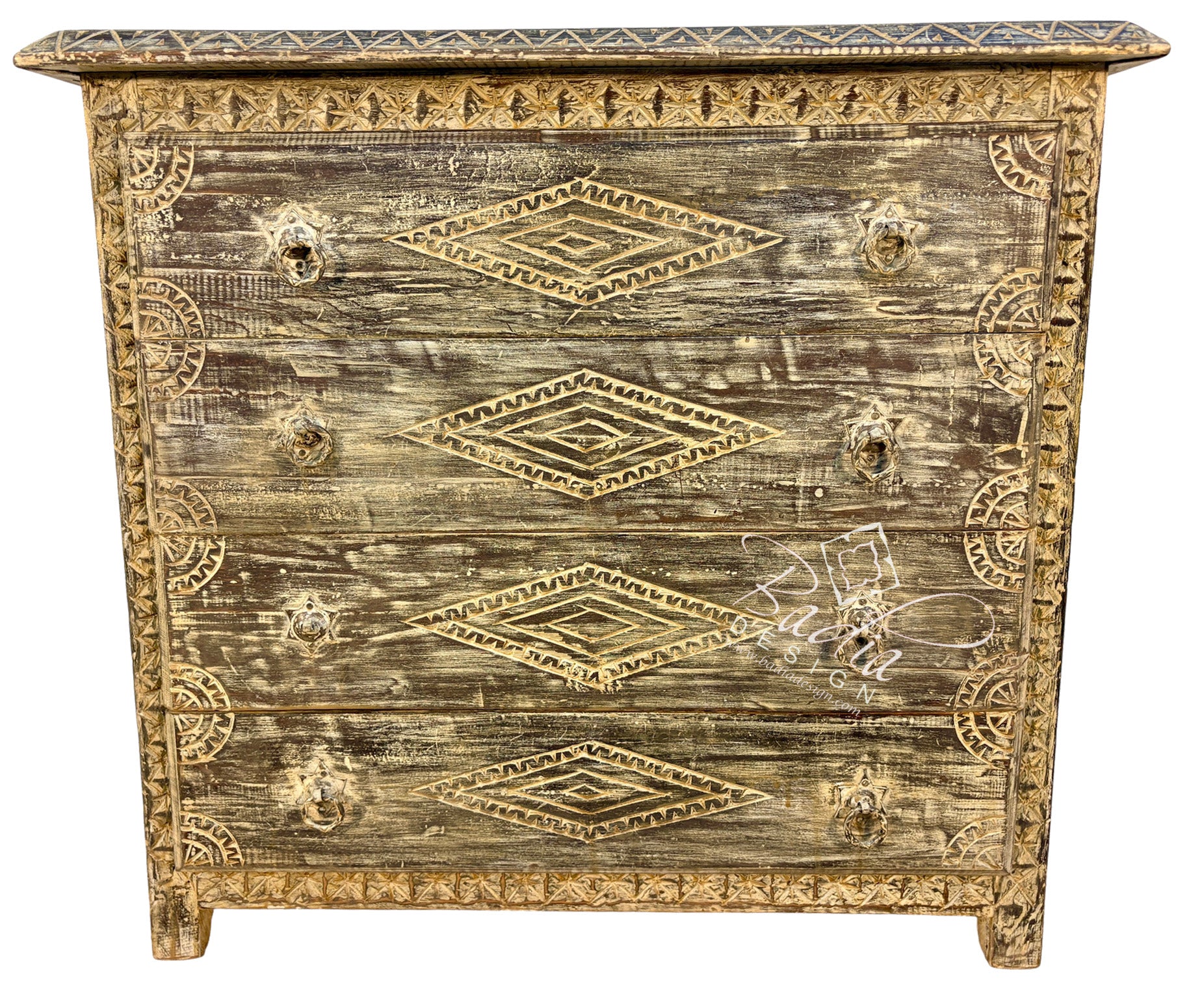 A distressed wooden chest of drawers with a weathered brown and beige finish, decorated with gold-toned geometric patterns and ornate drawer pulls.