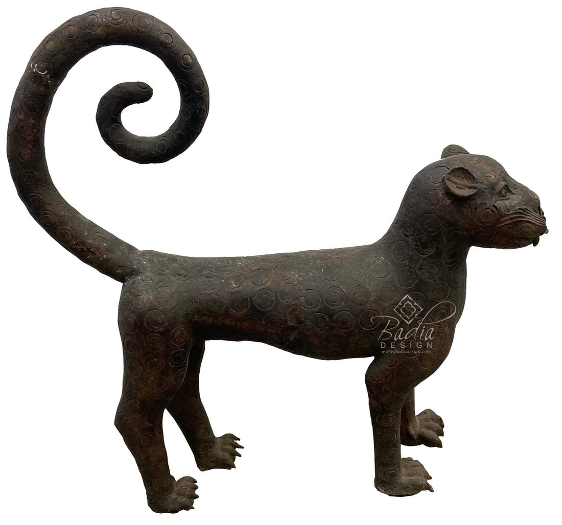 Large antique Bronze saber-tooth sculpture in a standing position side view.