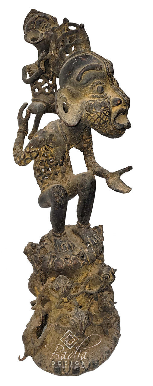 Bronze sculpture of a figure with intricate details on a white background