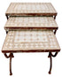 A three-tier nesting side table with distressed brown metal frames and patterned mosaic tile tops in cream and beige, isolated on a white background.