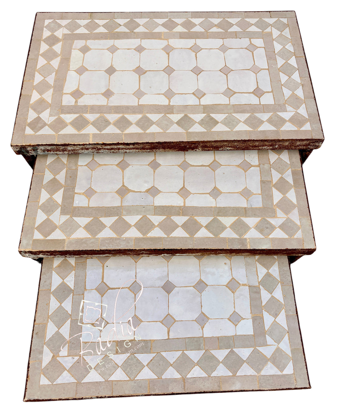Three rectangular nesting tables stacked vertically, featuring a geometric mosaic tile pattern in beige and off-white.