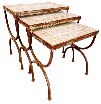 Three nested nesting tables with distressed rust-brown metal frames and cream mosaic tile tops, shown on a white background.