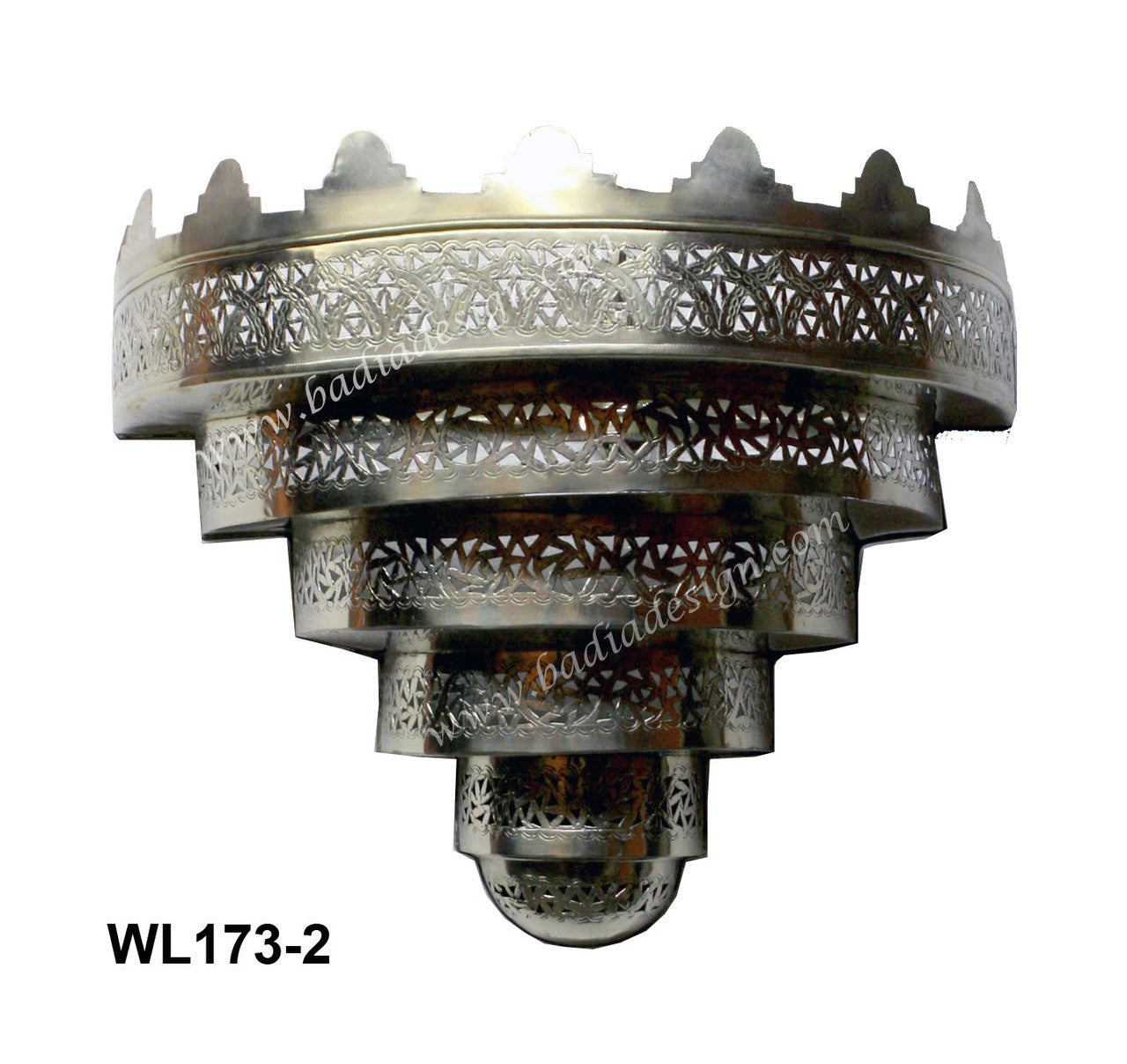 Decorative silver metal wall light fixture with intricate patterns on a white background