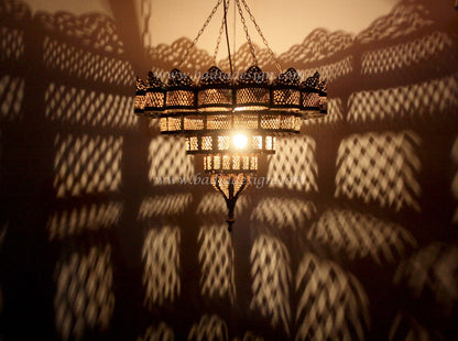 Decorative chandelier casting shadows on a wall