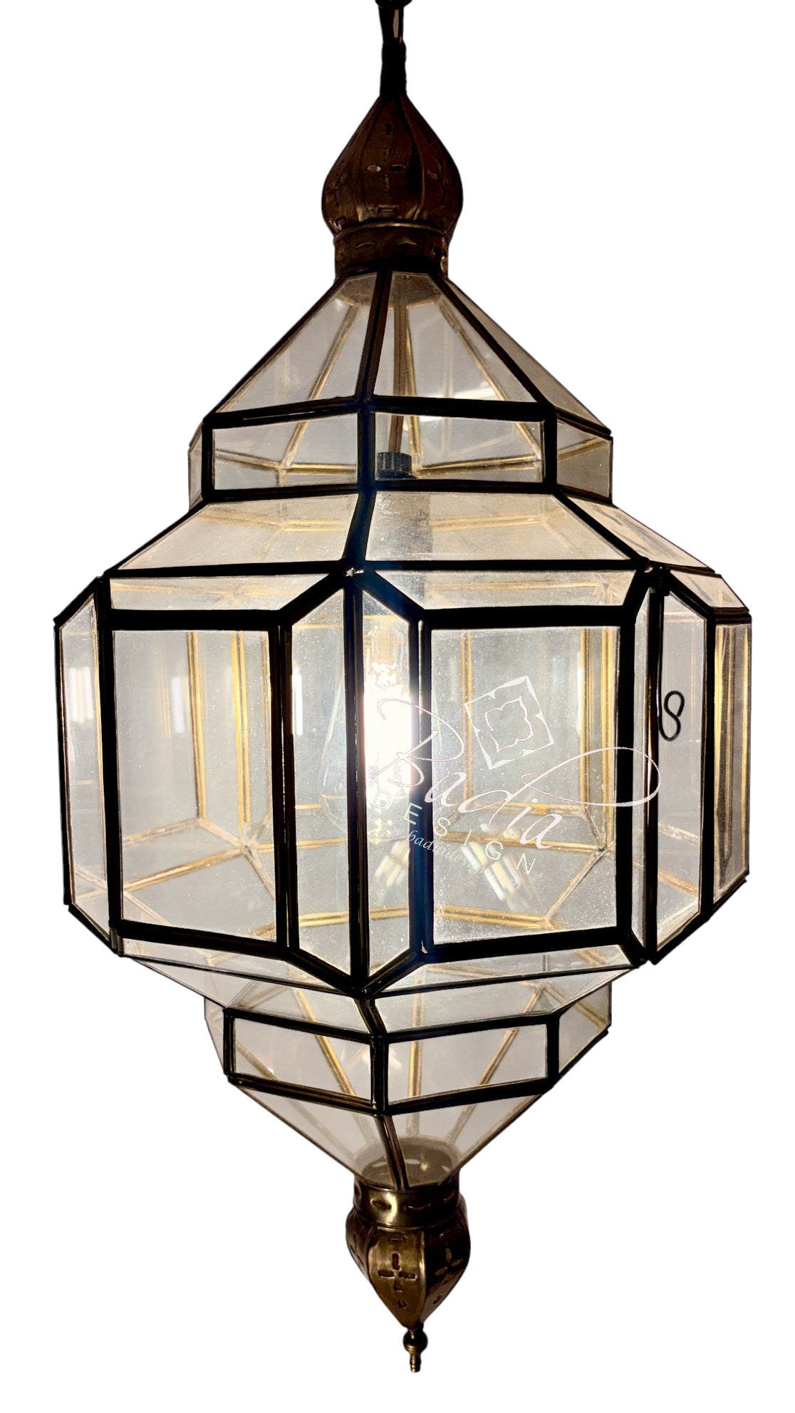 A geometric hanging lantern pendant light with clear glass panels and black metal framing, featuring brass-toned metal fittings at the top and bottom, shown against a plain white background.