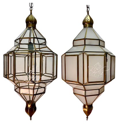 Two matching geometric hanging lantern-style pendant lights with clear glass panels and brass/gold-toned metal framing, shown side by side on a white background.