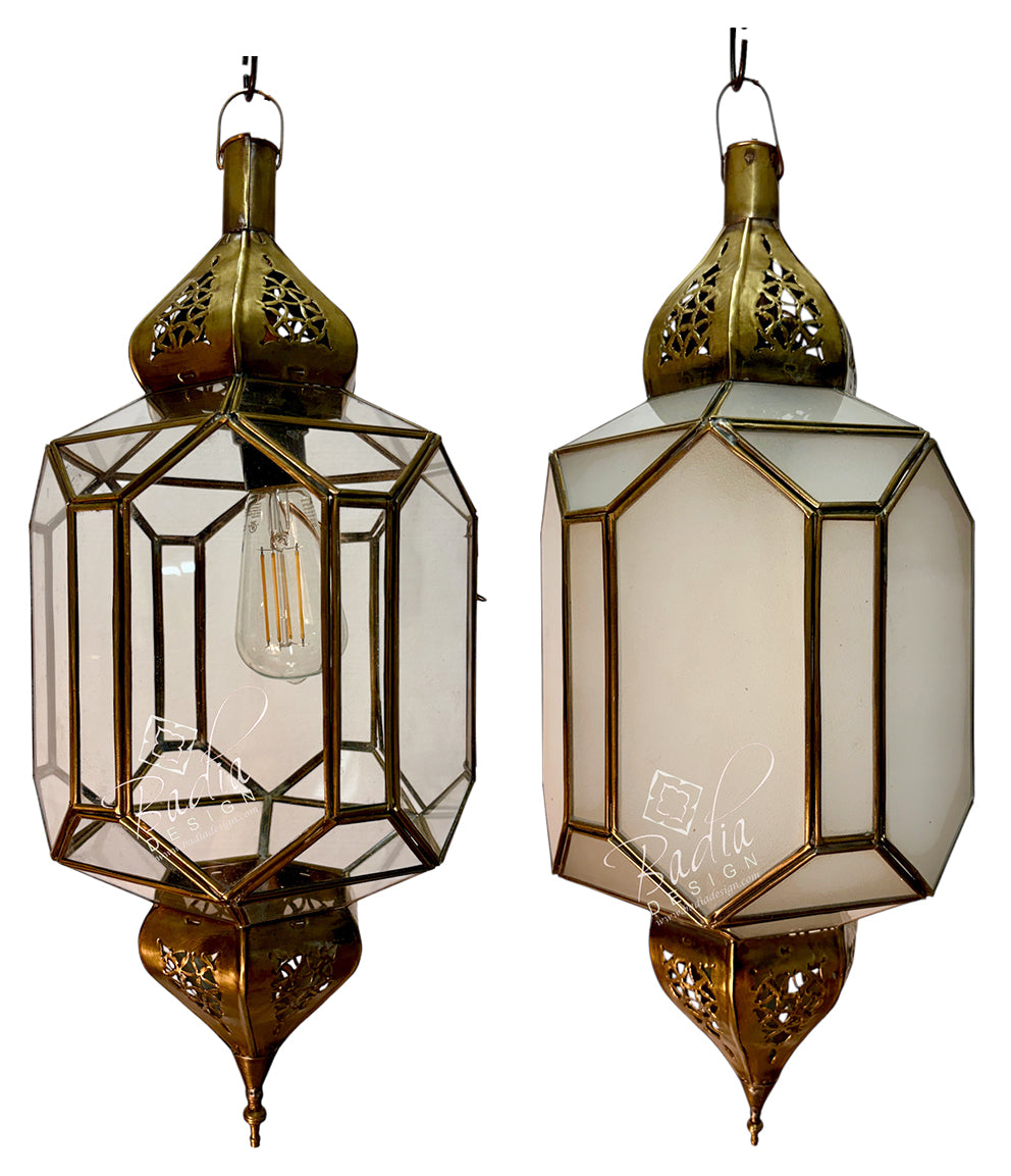 Two ornate hanging lanterns with brass-toned metal frames and clear glass panels, shown side by side against a white background. One lantern is open, revealing an exposed bulb, and the other is closed with a frosted or opaque inner panel.