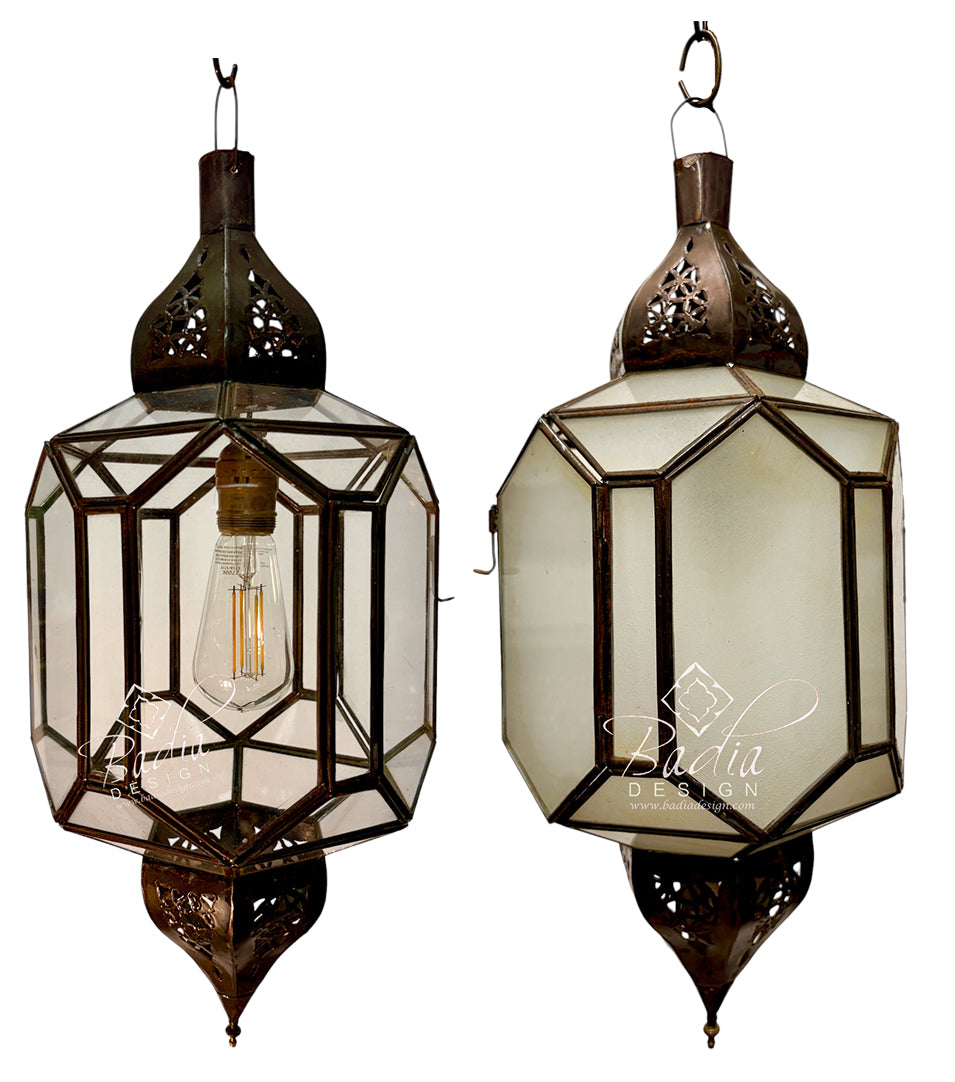 Two traditional Moroccan-style hanging lanterns with dark bronze metal frames and clear glass panels, shown against a plain white background. One lantern is open, displaying an Edison bulb, and the other shows the back with a &