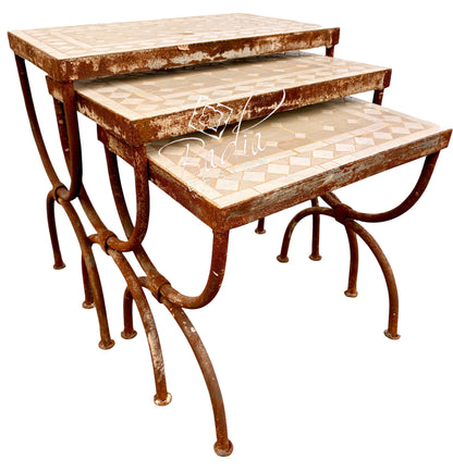 Three nested nesting tables with distressed brown metal frames and cream mosaic tile tops, shown on a white background.