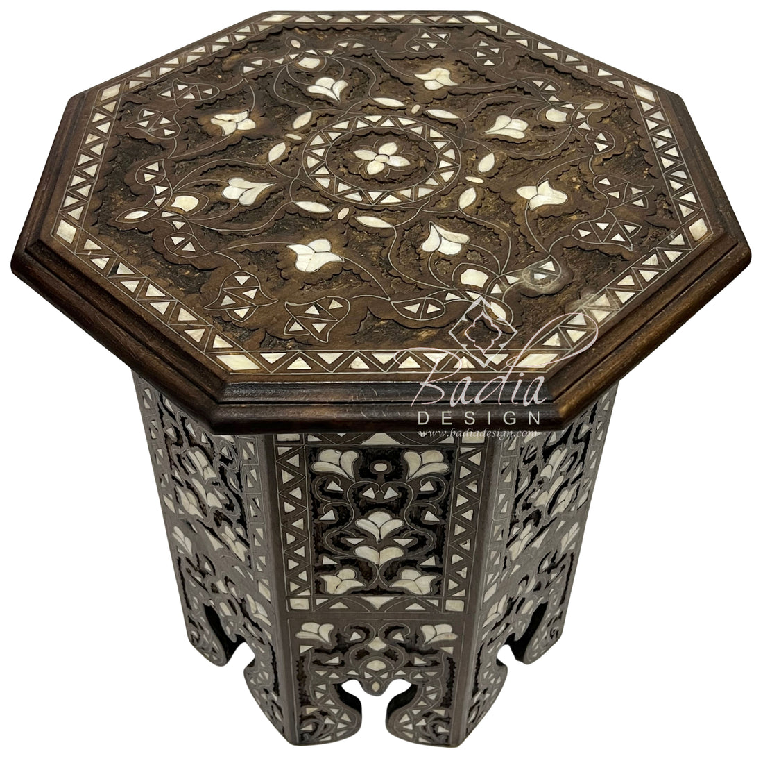 Decorative octagonal table with intricate patterns on a white background, featuring the Badia Design logo.