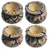 Four ceramic candle holders arranged in a 2x2 grid, each shown from a different angle. The holders have a warm cream base with hand-painted geometric and tribal patterns in navy blue, red, green, and orange.