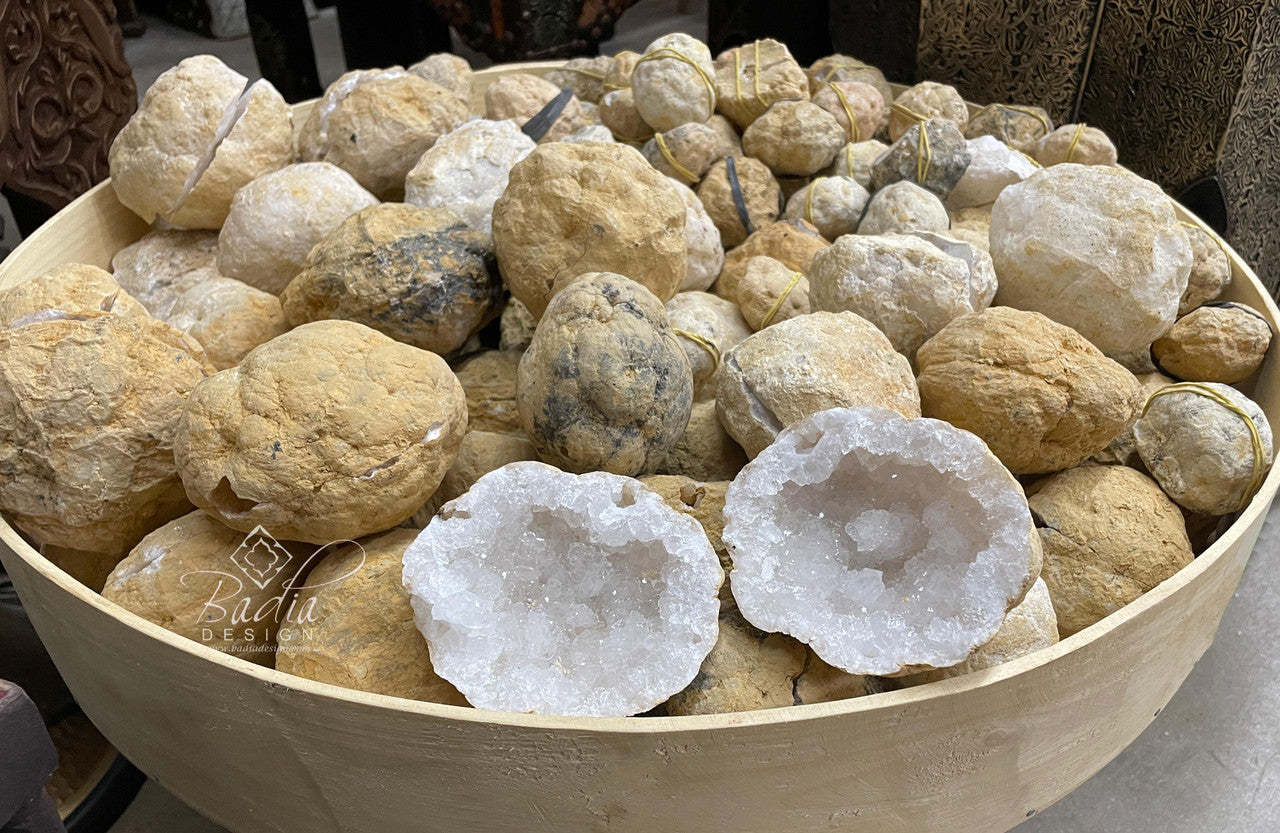 Bowl filled with various stones and crystals, including a prominent crystal formation.